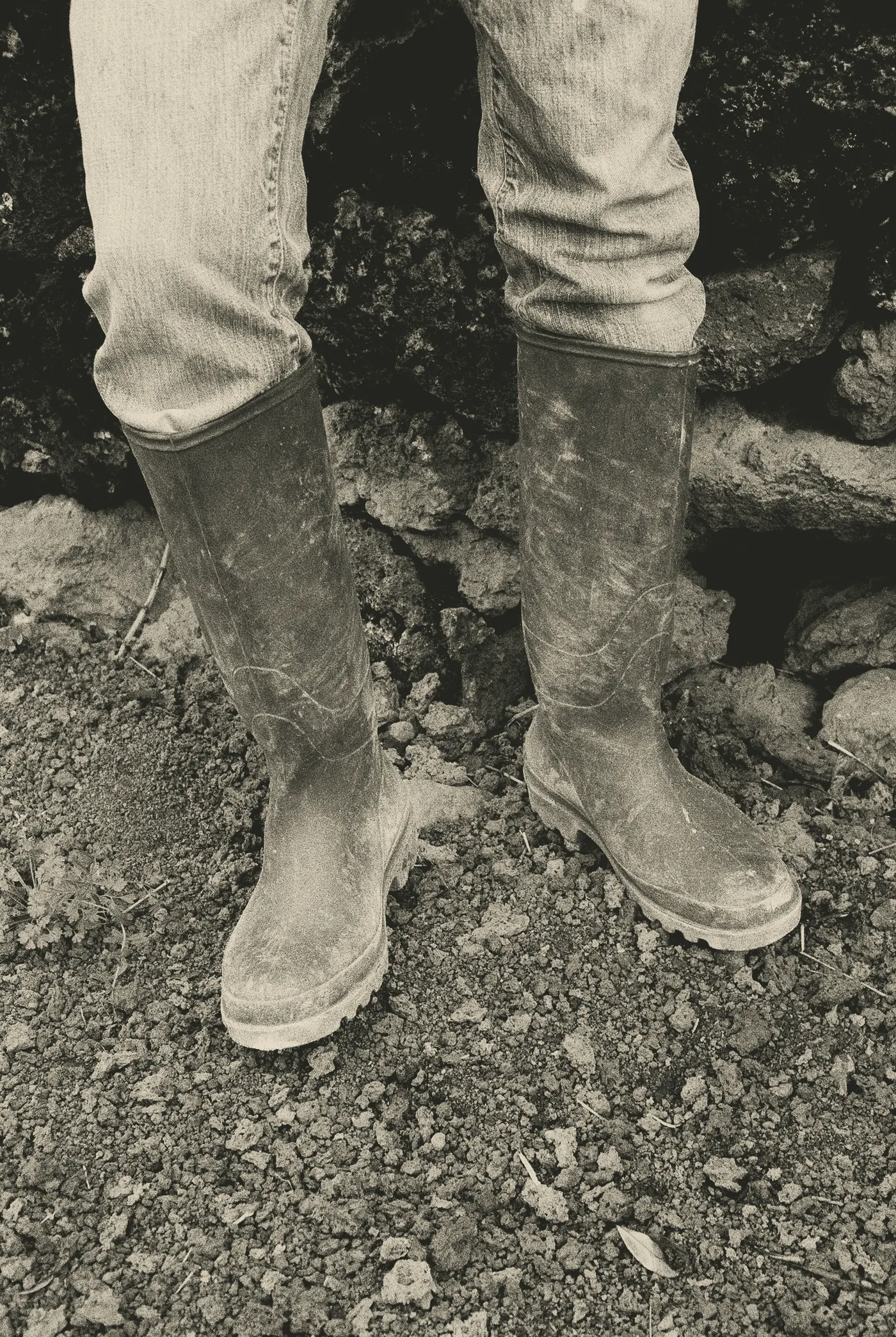 Muddy wellington boots on a farm track